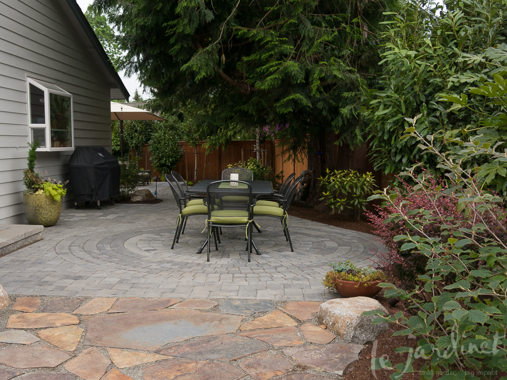 A new circular patio transformed the side garden, especially after the original flagstone was cleaned and re-set