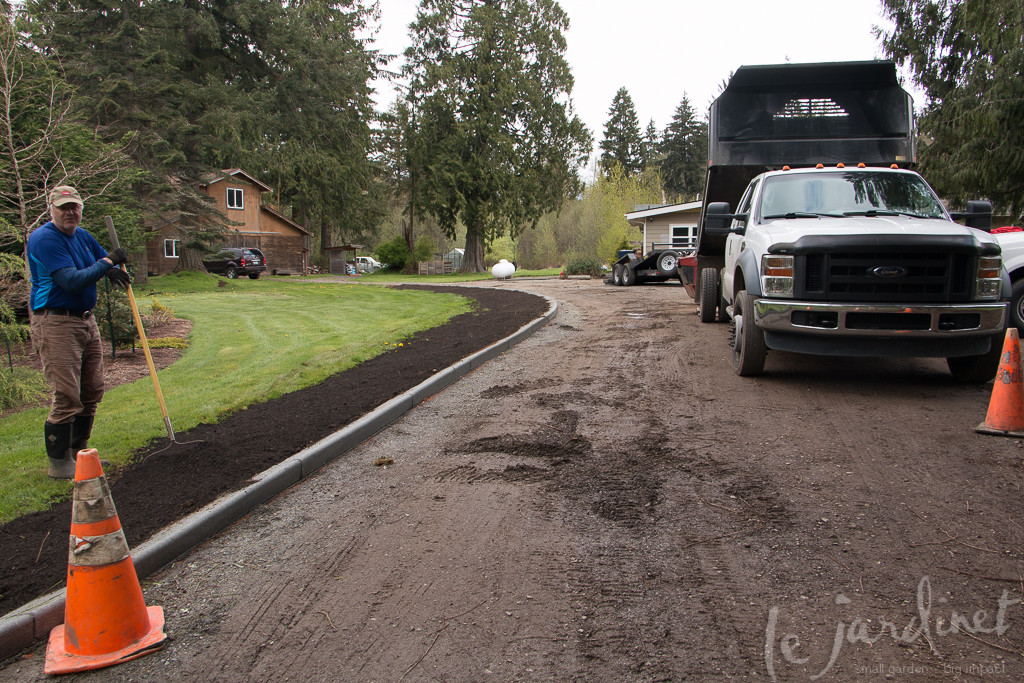 The crew from Berg's Landscaping preparing for gravel and easing the grade on the outer edges of the curbing