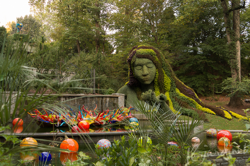 Seemingly rising from the water is the botanical masterpiece Earth Goddess